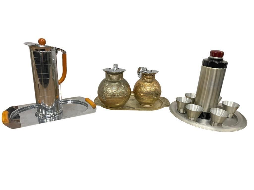Manning Bowman Serveware: Manning Bowman cocktail shaker, "Geniality" model. Approx. 12 1/4" x 4. Also, Westbend R.N Kircher Century of Progress 1933 Chicago Worlds art fair cocktail shaker, w/ 6 cups. Approx. 11 1/4"H. Also, 