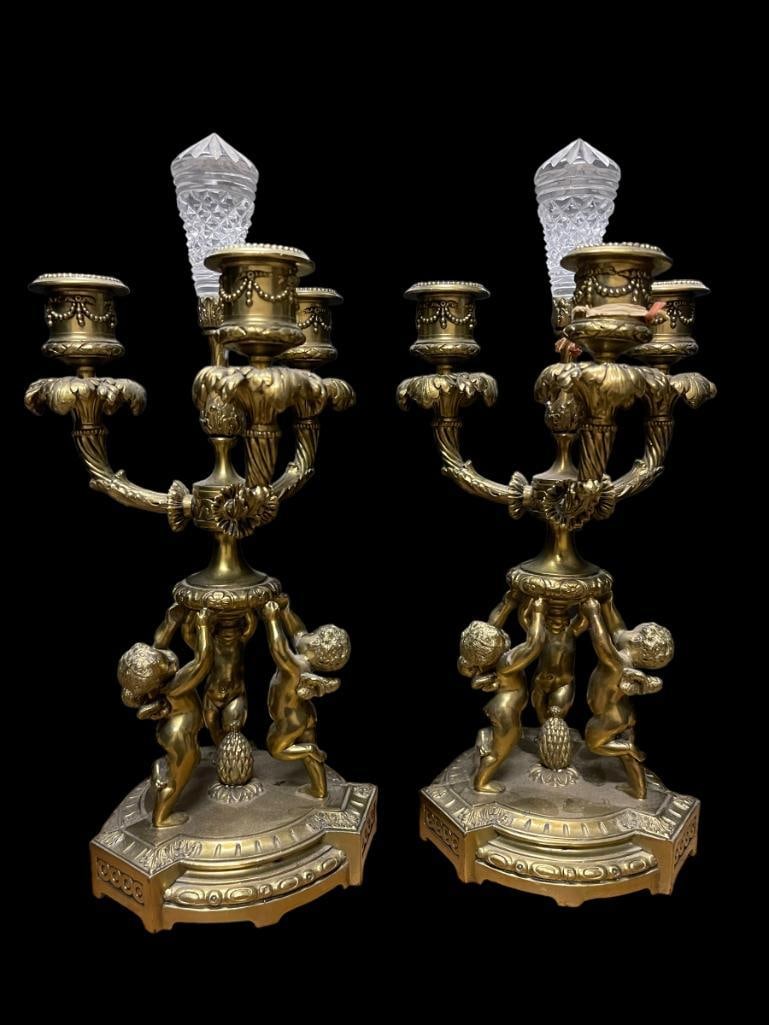 Pair of Pairpoint 3 Arm Candelabras: Pair of Pairpoint 3 Arm white medal Candleabras with cherubs and crystal tops; approx. 13"h