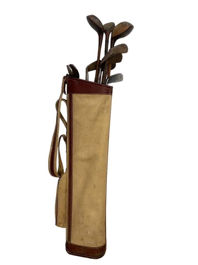 Group of wood handle golf clubs and bag: Group of wood handle golf clubs and bag. Approx. 13 pieces. 44x4x10 in.