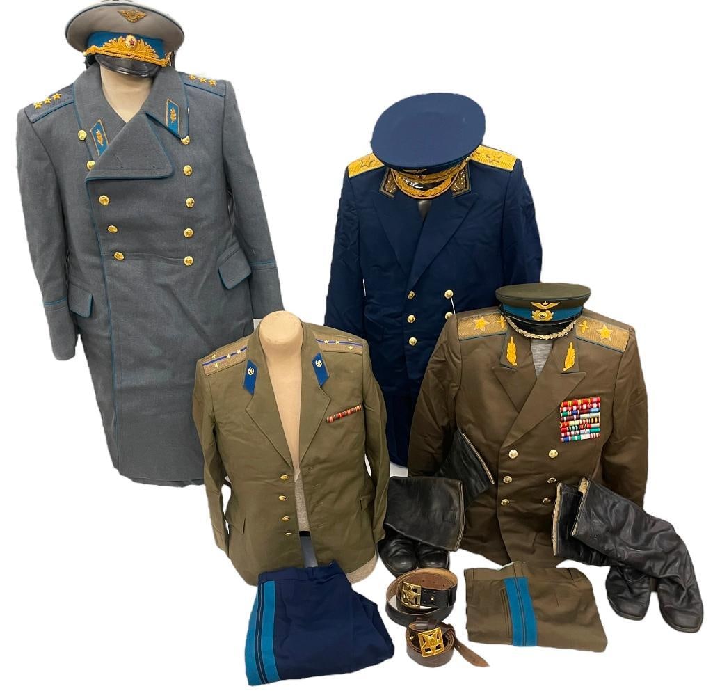 Lot of Soviet Air Force uniforms and coat.: Mixed lot of Soviet Air Force dress uniforms, winter coat for a Colonel General, parade hats, boots, belts and more. Approximately 16 pieces. 48x24x5 in.