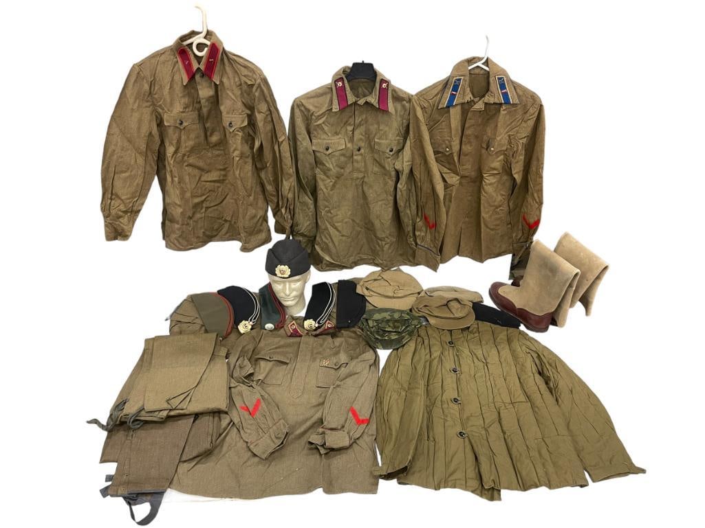 Mixed lot of Soviet military uniforms, hats and boots.: Mixed lot of Soviet military uniforms, hats and boots. Approximately 22 pieces. 32x24x5 in.