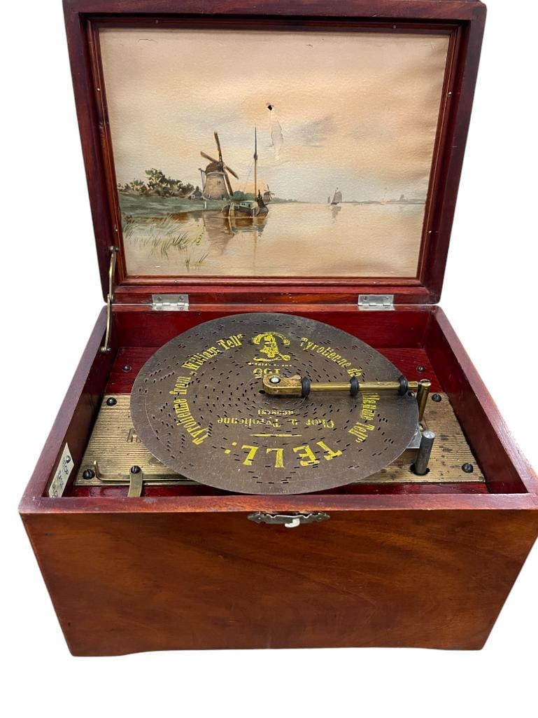 Regina Music box with 10 discs: Regina Music box with 10-8 inch discs. Approx. 12x9x8 inches.