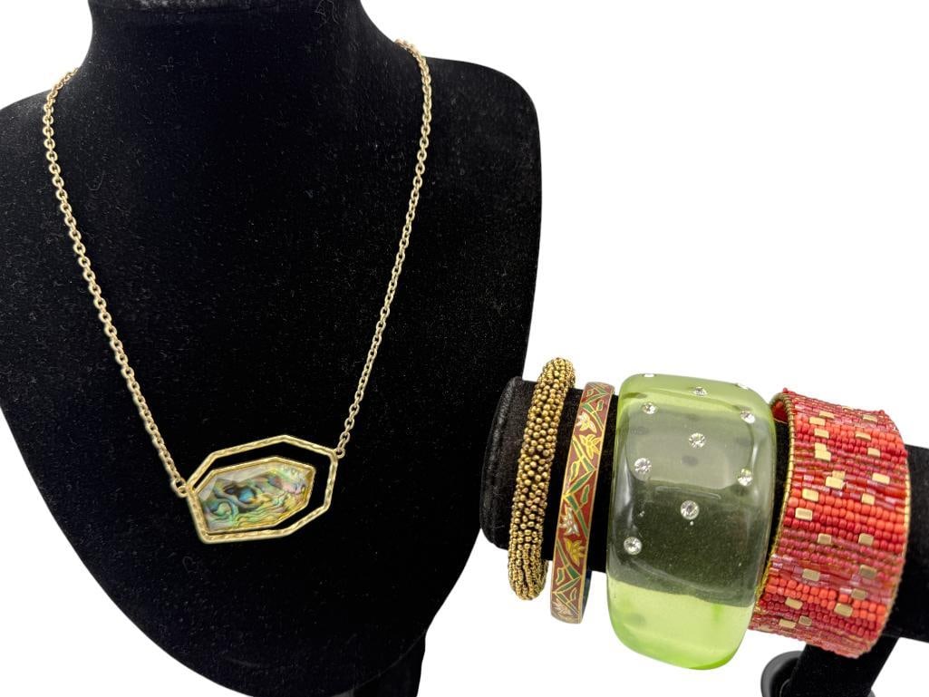 Group Costume Jewelry Bangles, Bracelets and more: Group Costume Jewelry. Green Lucite and Rhinestone Bangle, Coral Color Beaded Bangle, Gold Tone Bracelet, Cloisonne on Brass Bangle and Necklace with Pendant. 5 pieces.