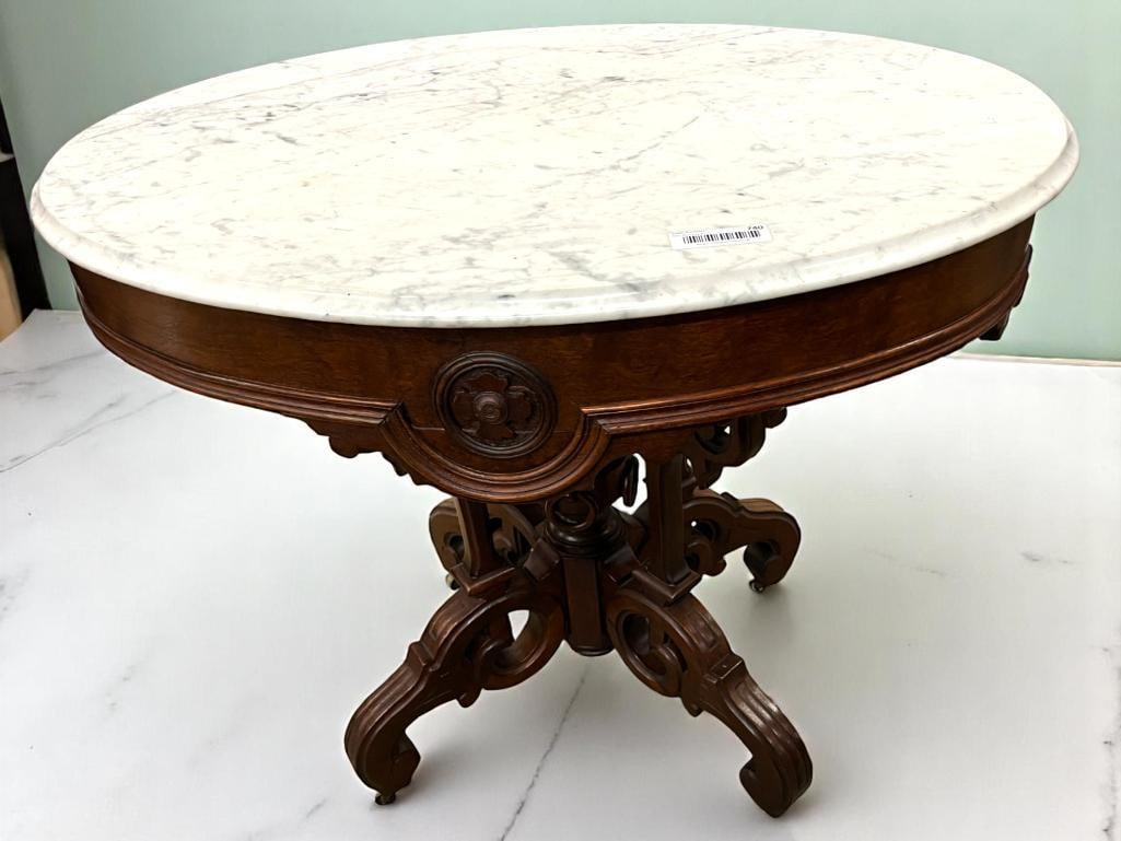 Oval Marble Top Walnut Table: Oval Marble Top Walnut Table. Approx. 30 x 35 x 26 inches.