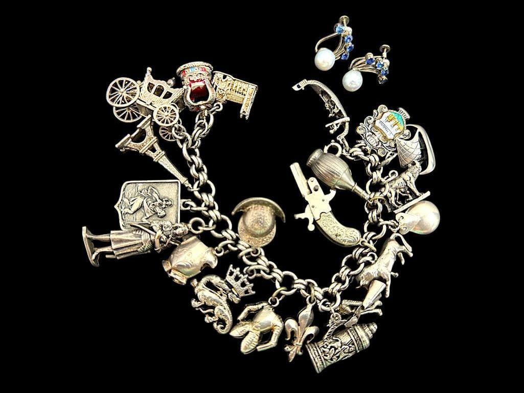 Group of Silver Bracelet Charms and Earrings: Group of Silver Bracelet Charms and Pearl with Sapphire screw back Earrings. Some charms are marked sterling.