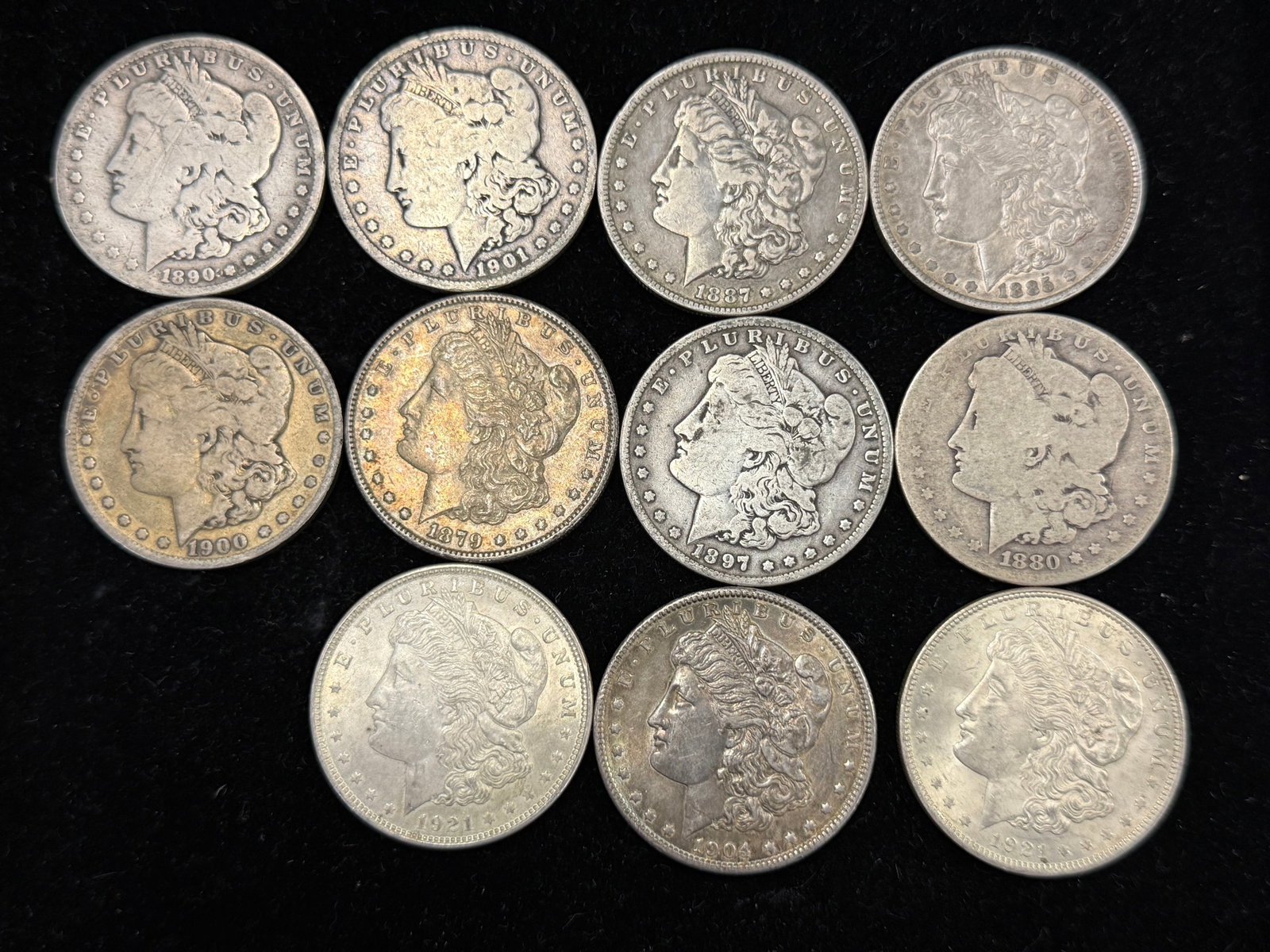 11 Morgan Silver Dollars: 11 Morgan Silver Dollars. 1879 S, 1885 O, 1887 O, 1890 O, 1880 O, 1897 O, 1900 S, 1901 O, 1904, (2) 1921.