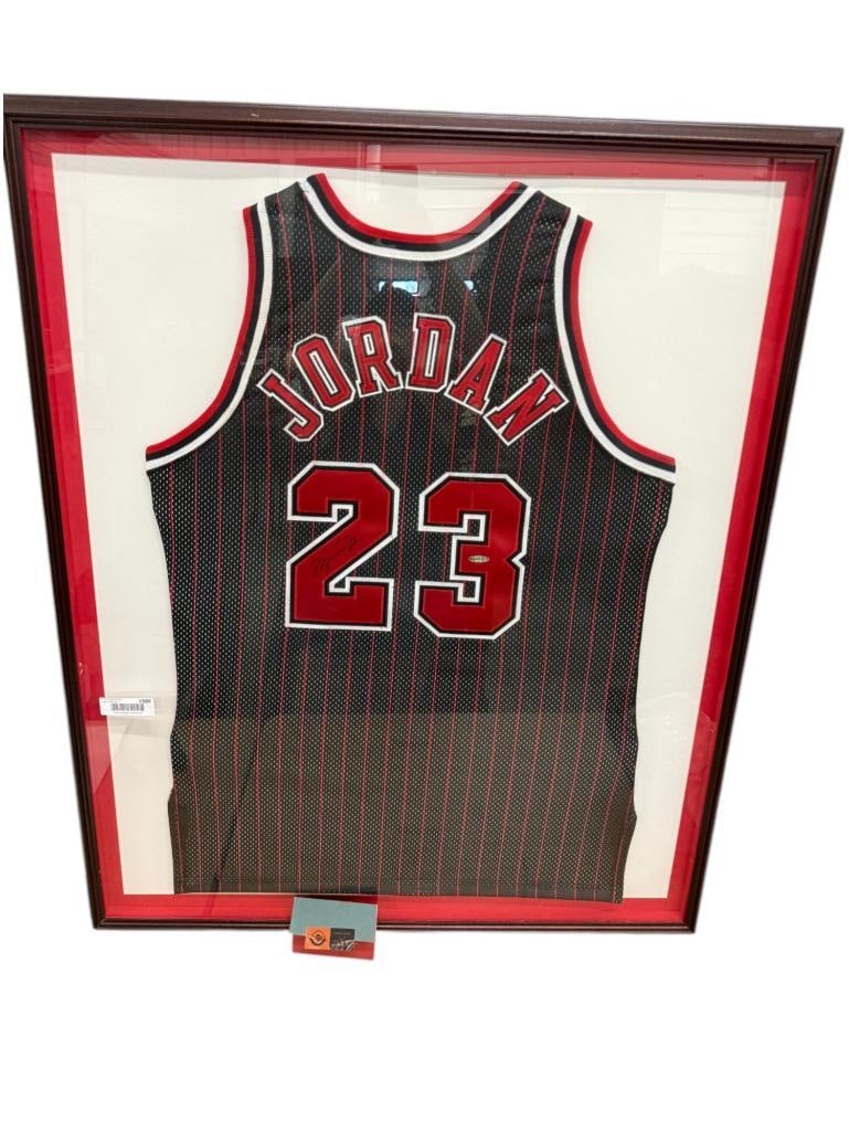 Michael Jordan Autographed Black 23 Jersey: 1995-96 Michael Jordan Autographed Black 23 Jersey. Includes Upper Deck Authentication. Frame approx. 34 x 43 inches.