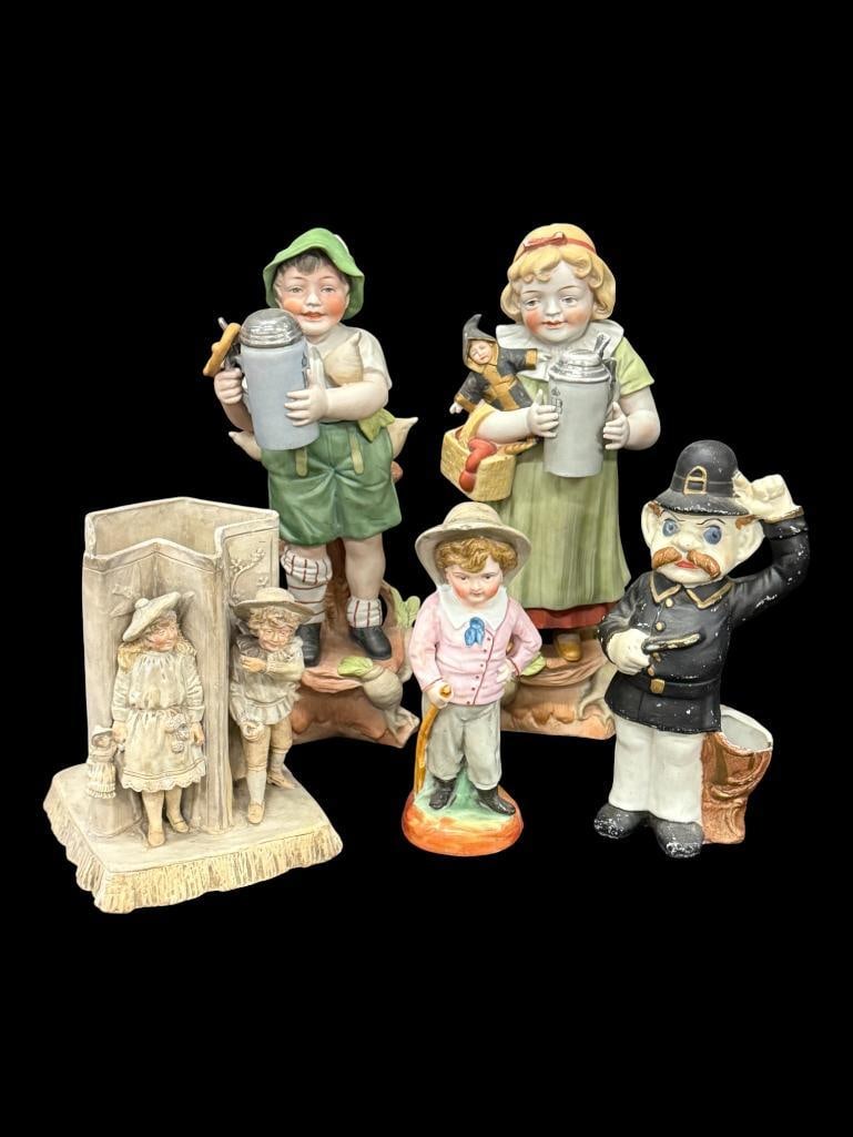 Porcelain Figurines with Steins and more: Porcelain Figurines with Steins, Police Officer and more. Boy with stein approx. 12 inches tall. 5 pieces.