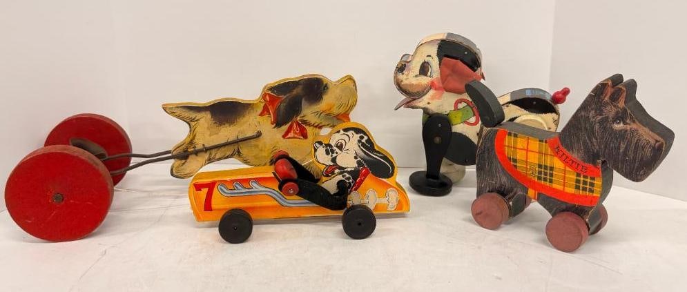 4 Fisher Price Dogs: 4 Vintage Fisher Price Dogs. Kiltie #450. White puppy #365. Racecar #7. Pulling bell #725.