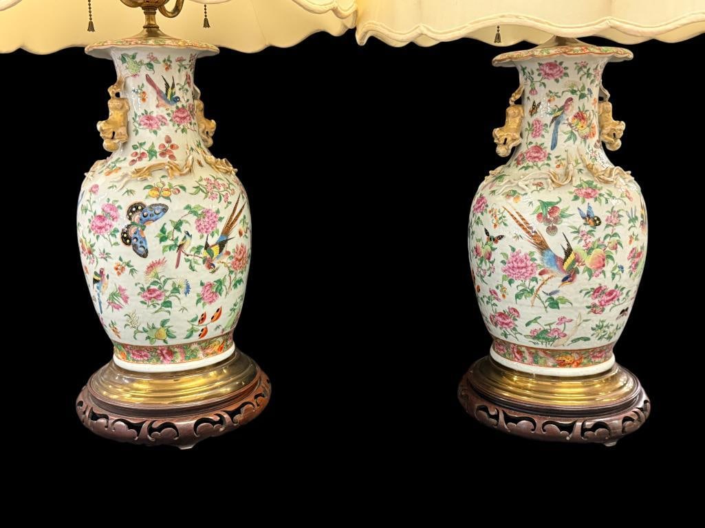 2 Chinese Famille Rose Vases / lamps: 2 Chinese Famille Rose Vases / lamps with Figural finials and Foo dog handles. Bird, Butterfly and floral designs. Vase approx. 16 x 9 inches. Total with shades approx. 40 x 20 x 20 inches.