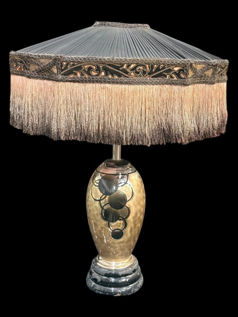 Table Lamp with Pleated Shade: Table Lamp with circle designs and Pleated Shade with fringe. Approx. 30 x 23 x 16 inches.