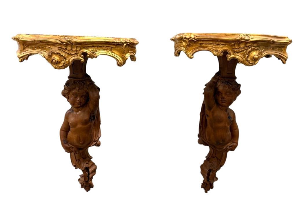 Pair of carved Cherub wall mounts: Pair of carved Cherub wall mounts. Approx. 26 x 18 x 12 inches.