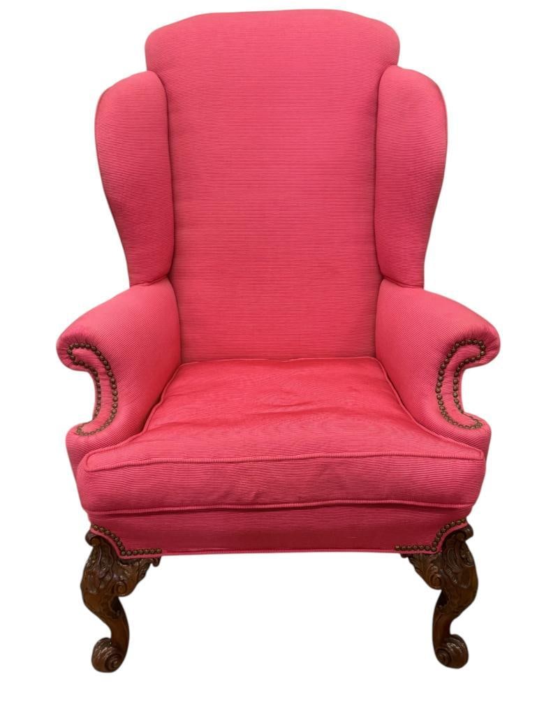 Pink Wingback Armchair: Pink Wingback Armchair with carved wood legs. Approx. 48 x 31 x 32 inches.