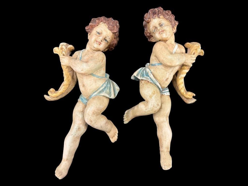 Pair of Cherub Hanging wall Sculptures: Pair of wood carved Cherub Hanging wall Sculptures. Approx. 19 x 10 x 5 inches.