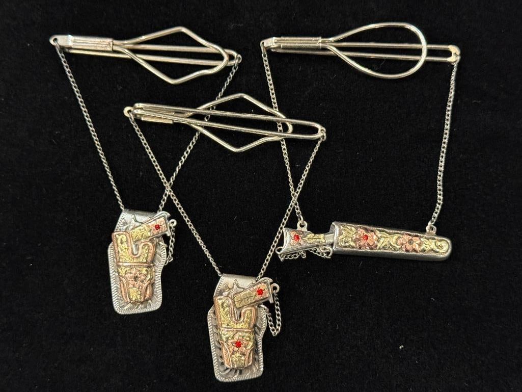 3 Sterling and Gold Cowboy Gun Tie bars: Tie bars are marked sterling. 2 are marked sterling 10k 18k. 1 marked sterling 10k. 3 pieces total.