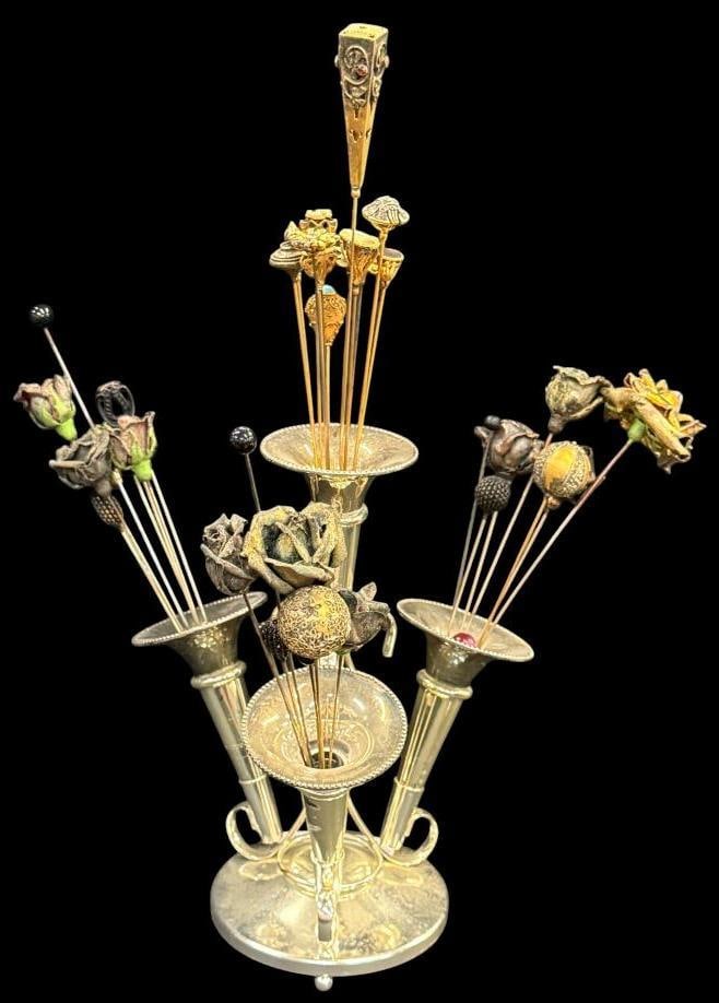 Silver plate Epergne with Hat Pins: Silver plate Epergne with Hat Pins. Approx. 35 hat pins, some with stones, swastika, flower shapes and more. Epergne approx. 10 x 10 x 10 inches.