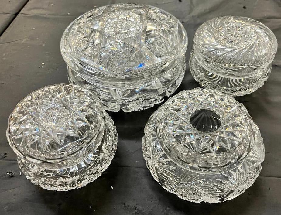 4 Cut glass dresser jars: 4 Cut glass dresser jars. Largest approx. 4 x 7 x 7 inches.