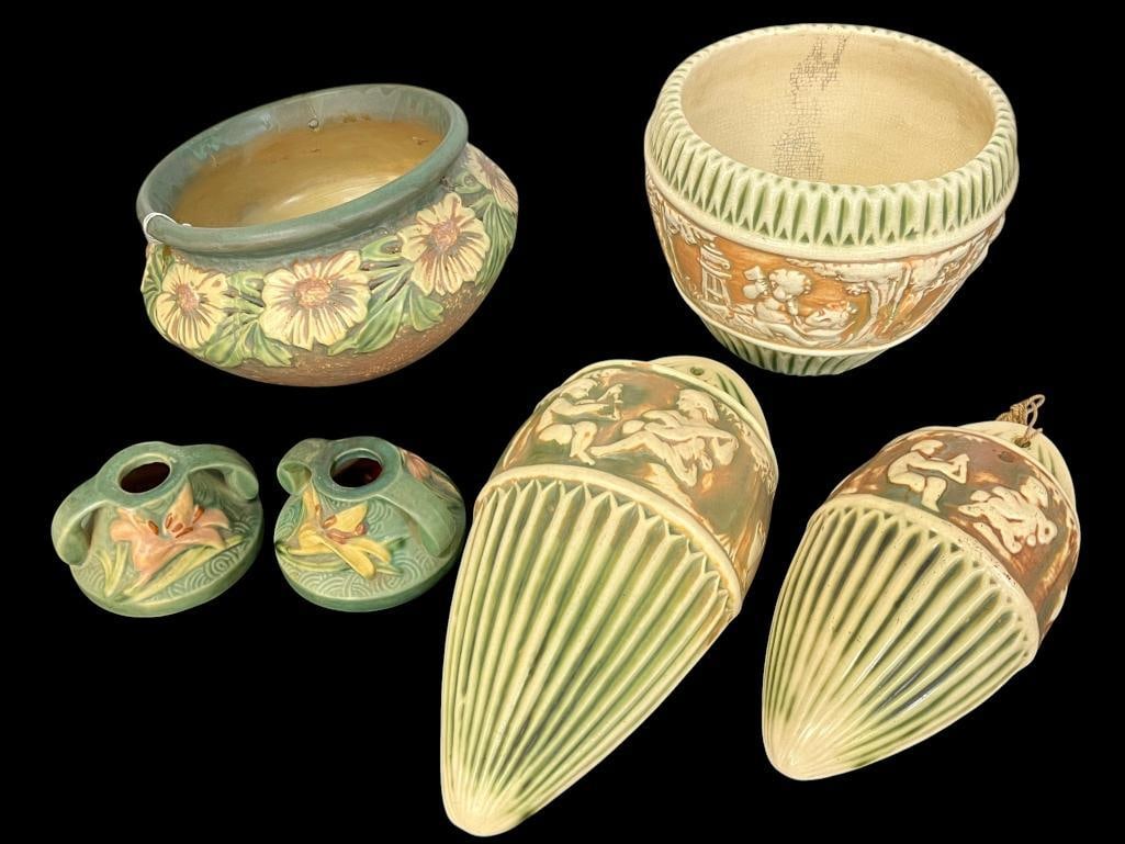 Roseville Donatello, Dahlrose and Zephyr Lily pieces: Roseville Donatello wall pockets and pot, Dahlrose hanging basket and Zephyr Lily candle holders. 6 pieces. Basket approx. 5 x 8 x 8 inches.