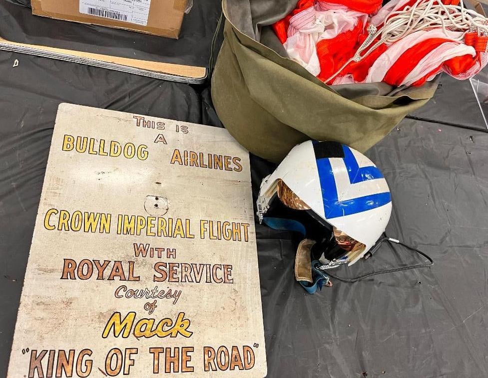 Pilots Helmet, parachute and Bulldog Airlines sign: Pilots Helmet, parachute and Bulldog Airlines sign, with Royal Service courtesy of Mack.. 3 pieces. Sign approx. 22 x 17.5 inches.