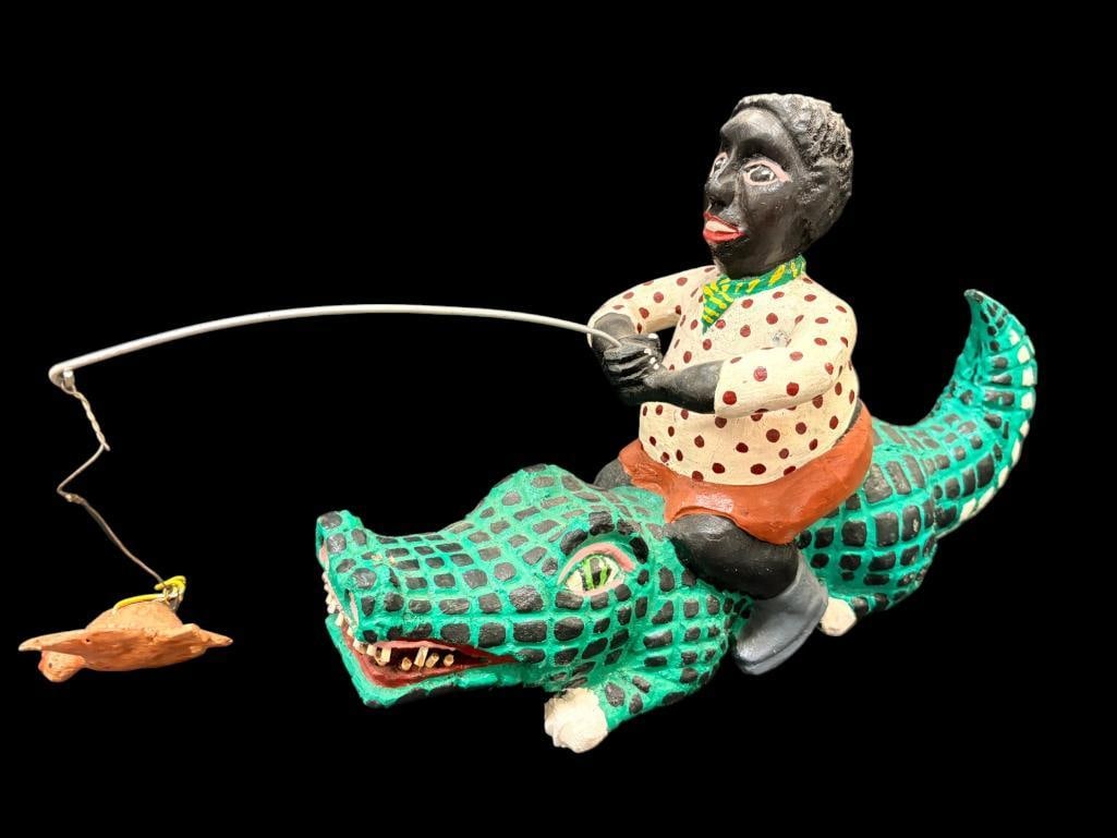 Bill Duffy signed Black Americana wood carving: Bill Duffy signed Black Americana sculpture. Boy riding alligator with chicken. Approx. 11 x 19 x 5 inches.