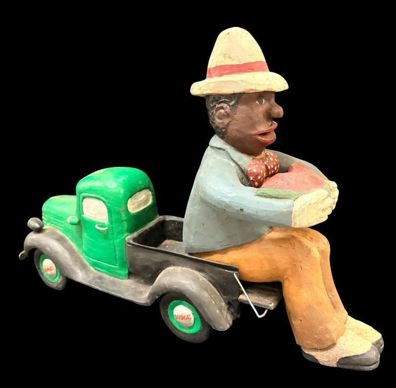 Bill & Phyllis Duffy signed Black Americana wood carving: Bill & Phyllis Duffy signed Black Americana sculpture. Man on pickup truck eating watermelon. Approx. 15 x 22 x 6 inches.