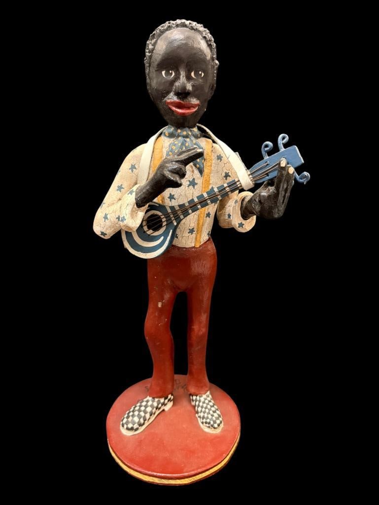 Bill & Phyllis Duffy 1988 signed Black Americana wood carving: Bill & Phyllis Duffy 1988 signed Black Americana sculpture. Playing a guitar, Approx. 17 x 6 x 6 inches.