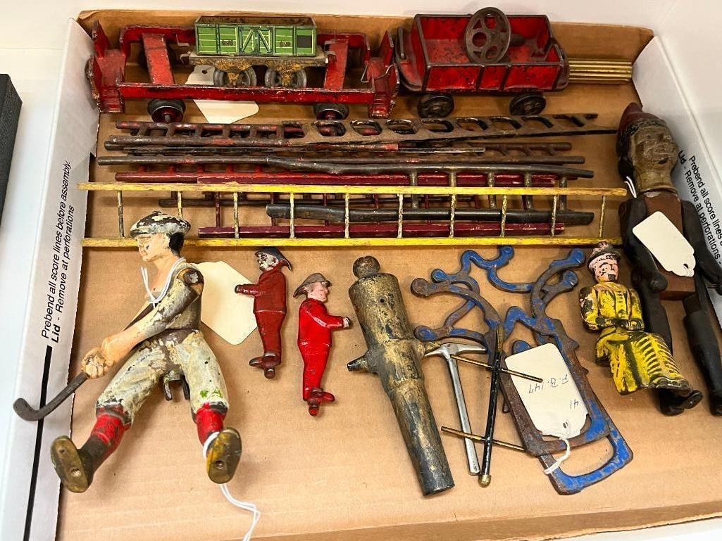 Cast iron toy fire truck ladders and more: Cast iron toy fire truck ladders, figures, golfer and more. Approx. 20 pieces.