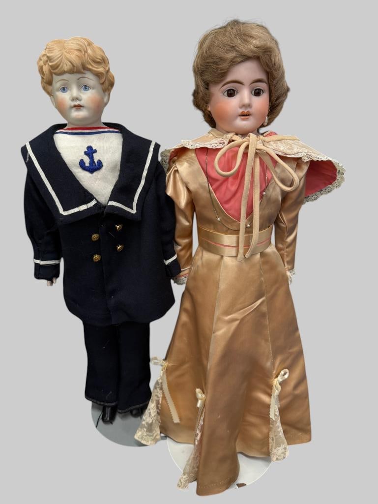 German porcelain doll and doll in Navy outfit: German porcelain doll and doll in Navy outfit. German doll marked with a Horseshoe, possibly Heubach. Tallest approx. 23 inches.