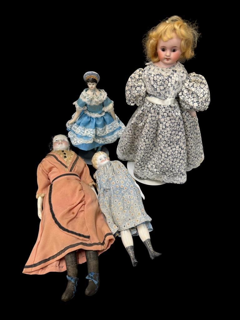 Group of 4 porcelain dolls: Group of 4 porcelain dolls. Tallest approx. 14 inches.