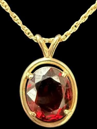 Garnet Pendant with 14k Gold Chain: Garnet Pendant with 14k Gold Chain. Total weight approx. 5 grams. Chain from clasp to pendant approx. 8.5 inches.