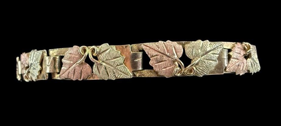 Black Hills Gold Bracelet: Black Hills Gold Bracelet. Marked 10-12k Gold. Chain and Catch are gold filled. Total weight approx. 10 grams.