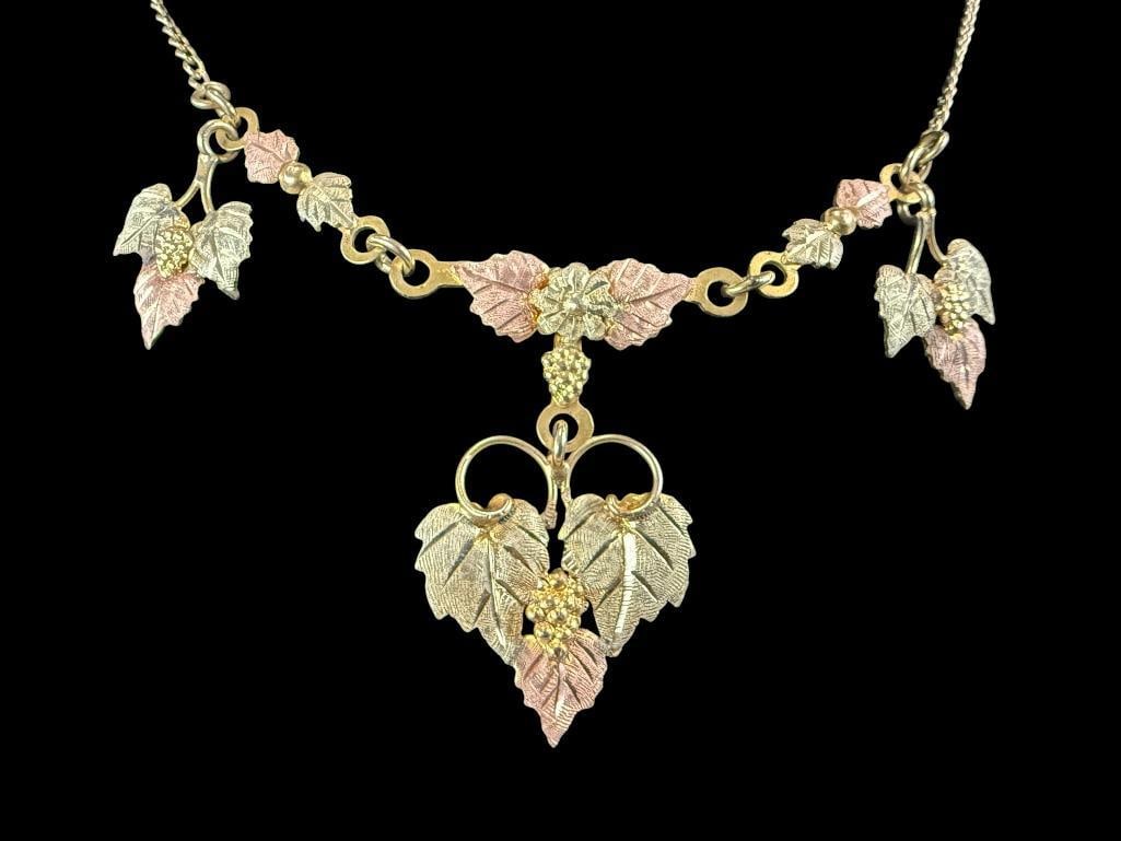 Black Hills Gold Pendant and chain: Black Hills Gold Pendant marked 10-12k and chain is Gold Filled. Total weight approx. 7.4 grams.