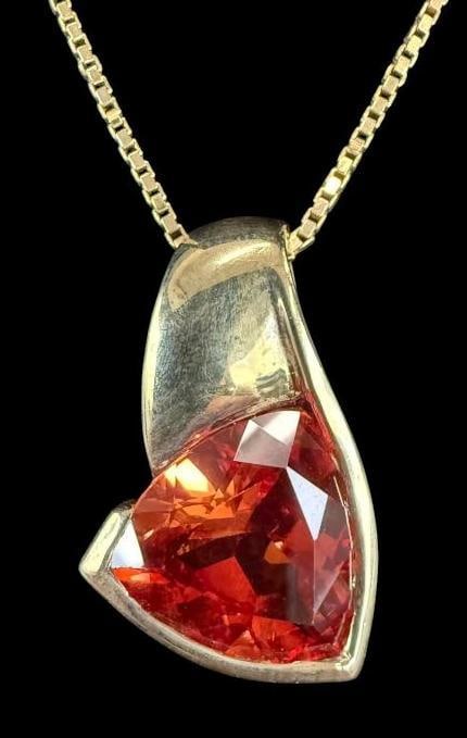 14k Gold Necklace with Orange Sapphire pendant: 14k Gold Necklace with Synthetic Orange Sapphire pendant. Total weight approx. 6.4 grams. Clasp to pendant approx. 8.5 inches.