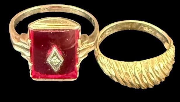 2 10k Gold Rings: 2 10k Gold Rings. 1 with red stone. Approx. 5.9 grams. Red stone ring approx. size 8. Gold ring approx. size 4.5.