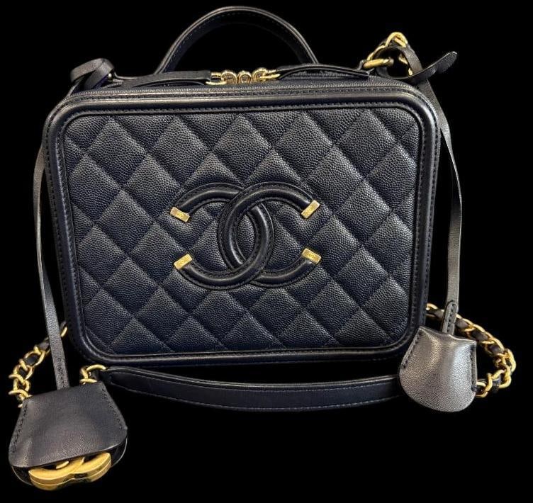 CHANEL Filigree Vanity Case: CHANEL Filigree Vanity Case Quilted Caviar. Serial # 26183475. Includes Chanel card, lock and key. Approx. 8.5 x 6.5 x 3 inches. Provenance: From an Italian collector.