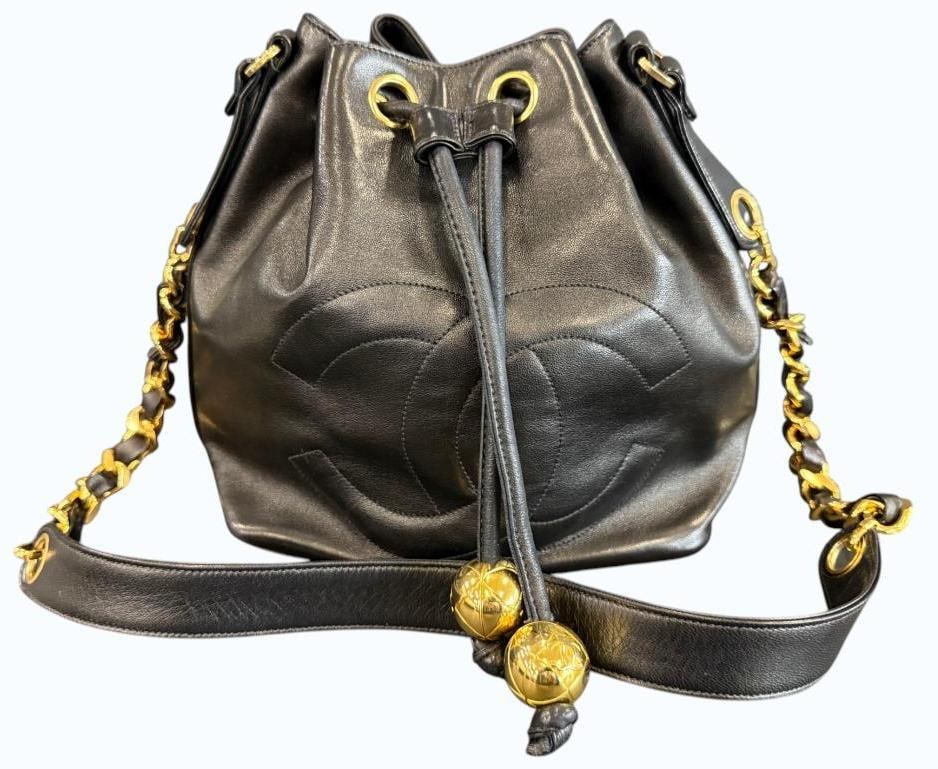 CHANEL Bucket Bag: CHANEL Bucket Bag in black lambskin. Serial # 2121399. Approx. 9 x 9 x 6 inches. Provenance: From an Italian collector.