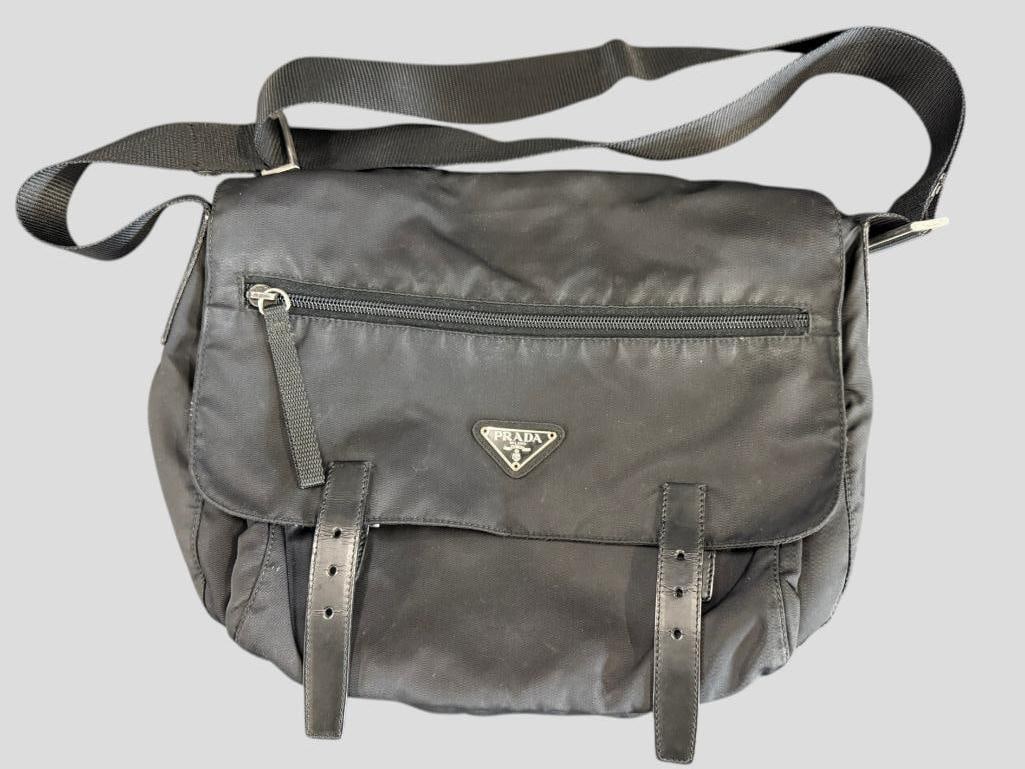 Prada Messenger bag: Prada Messenger bag in black nylon with leather. Missing one buckle. Approx. 13 x 10 x 5 inches. Provenance: From an Italian collector.
