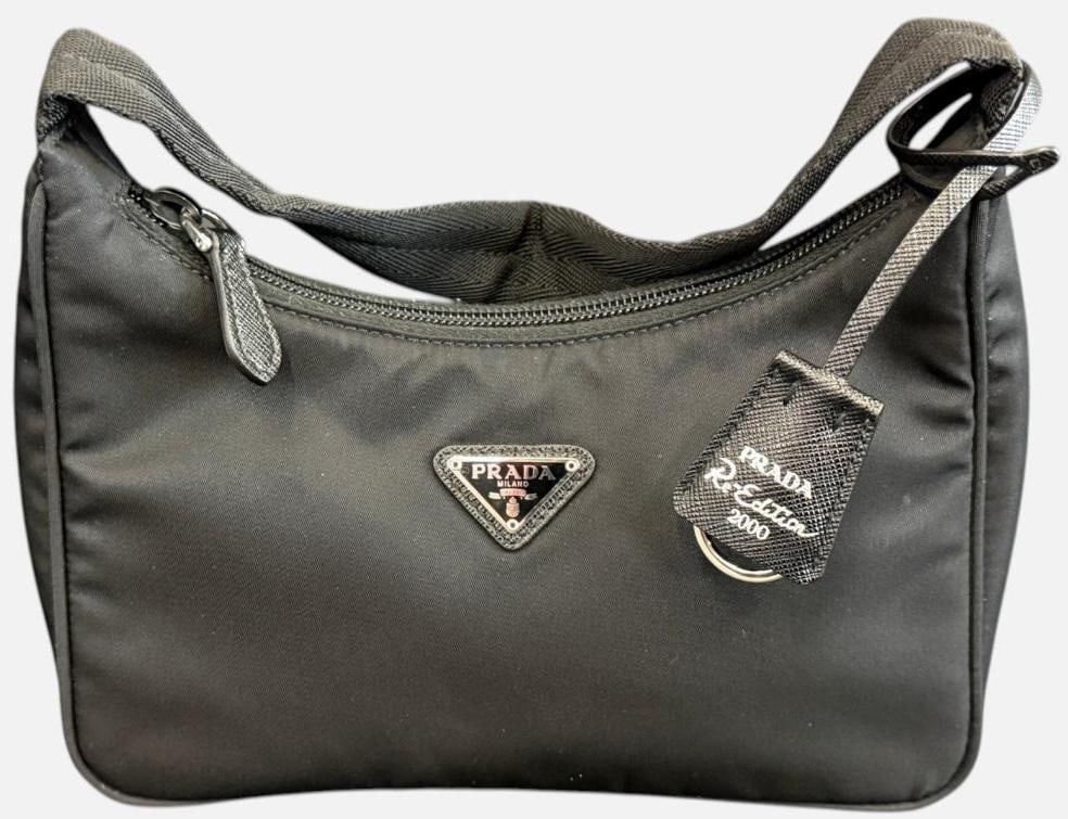 Prada Re-Edition 2000 Mini Handbag: Prada Re-Edition 2000 Mini Handbag in black nylon. Has RFID serial. Includes original pamphlet. Approx. 9 x 7 x 2.5 inches. Provenance: From an Italian collector.