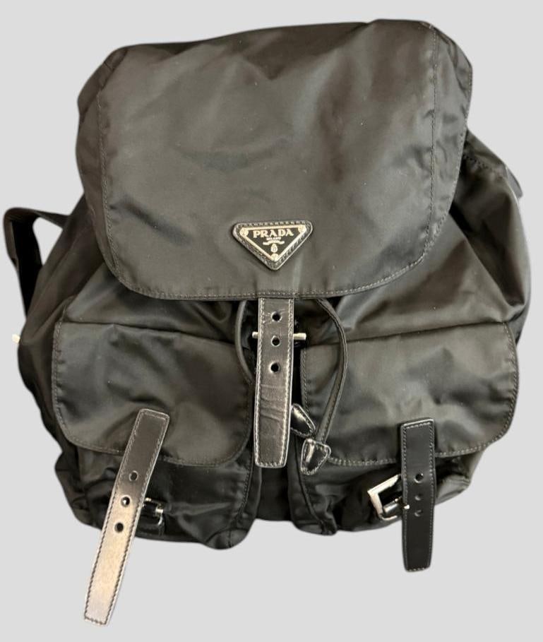 Prada Black Nylon Backpack: Prada Black Nylon Backpack. Comes with Official Prada Card and pamphlet. Approx. 13 x 14 x 6 inches. Provenance: From an Italian collector.