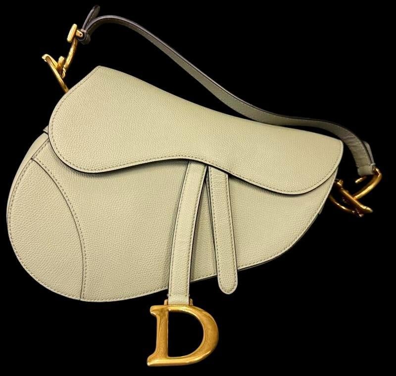 Dior Saddle Bag with Strap: Dior Saddle Bag with Strap. Serial # 05-RU-0210. Includes point of sale official card and pamphlet. Approx. 10 x 8 x 3 inches. Provenance: From an Italian collector.