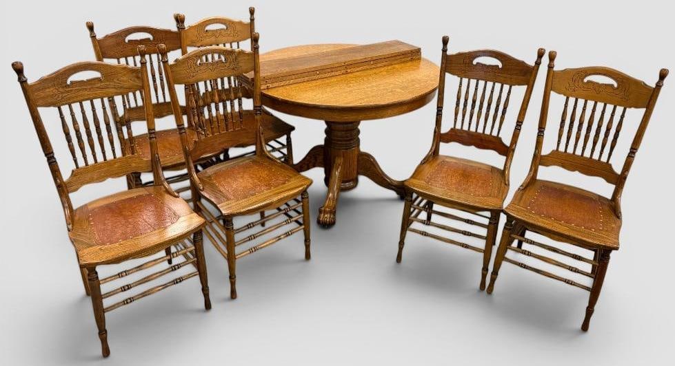 Oak Dining Table and Chairs: Oak Dining Table and 6 Chairs. Table closed approx. 42 inches round. Includes 3 - 8 3/4 inch leaves.Chairs approx. 39.5 x 17 x 17 inches.