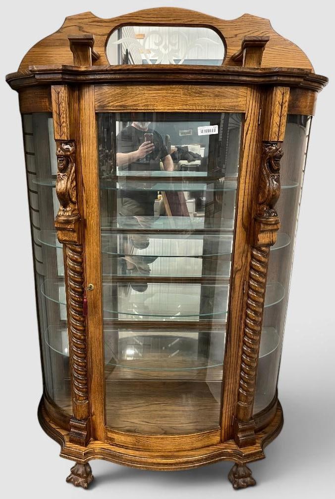Oak Bow Front China Cabinet: Oak Bow Front China Cabinet with carved Lions. Approx. 76 x 48 x 16 inches.