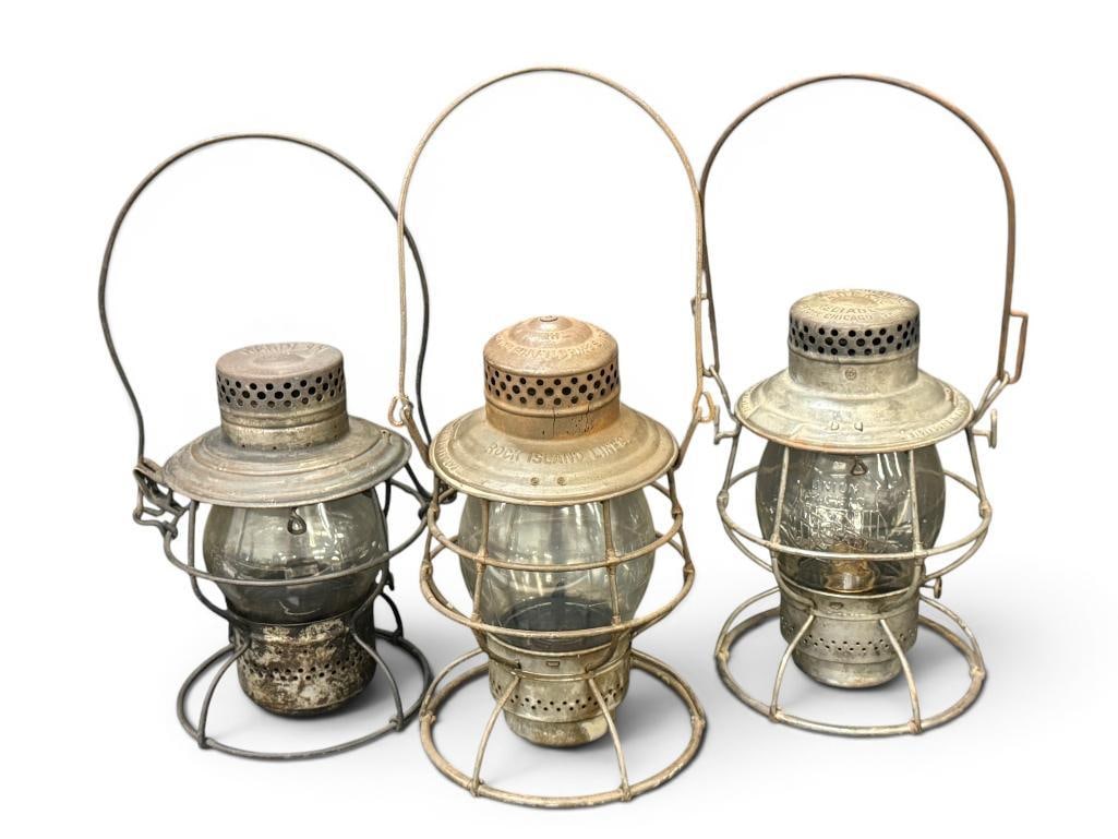 3 Railroad Lanterns: 3 Railroad Lanterns. Handlan marked PRR. Adlakes marked Union Pacific and Rock Island Lines. Approx. 9 x 7 x 7 inches.