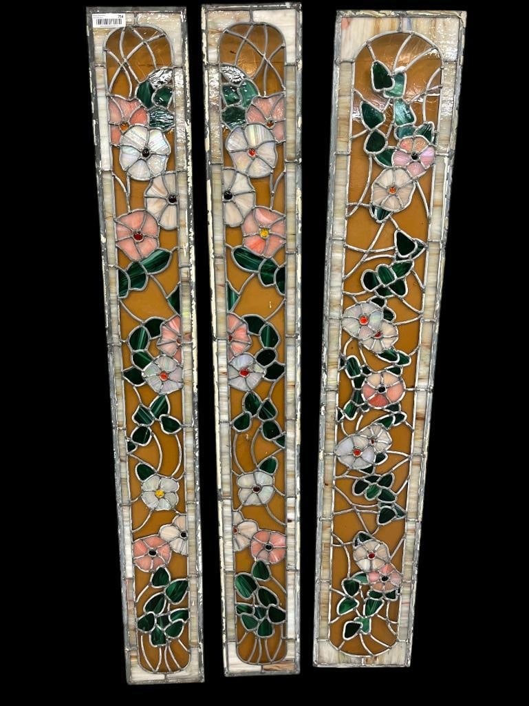 3 Leaded Glass window panels: 3 Leaded Glass window panels with floral designs. 2 panels are approx. 64 x 8 inches. 1 panel approx. 63 x 10.5 inches.
