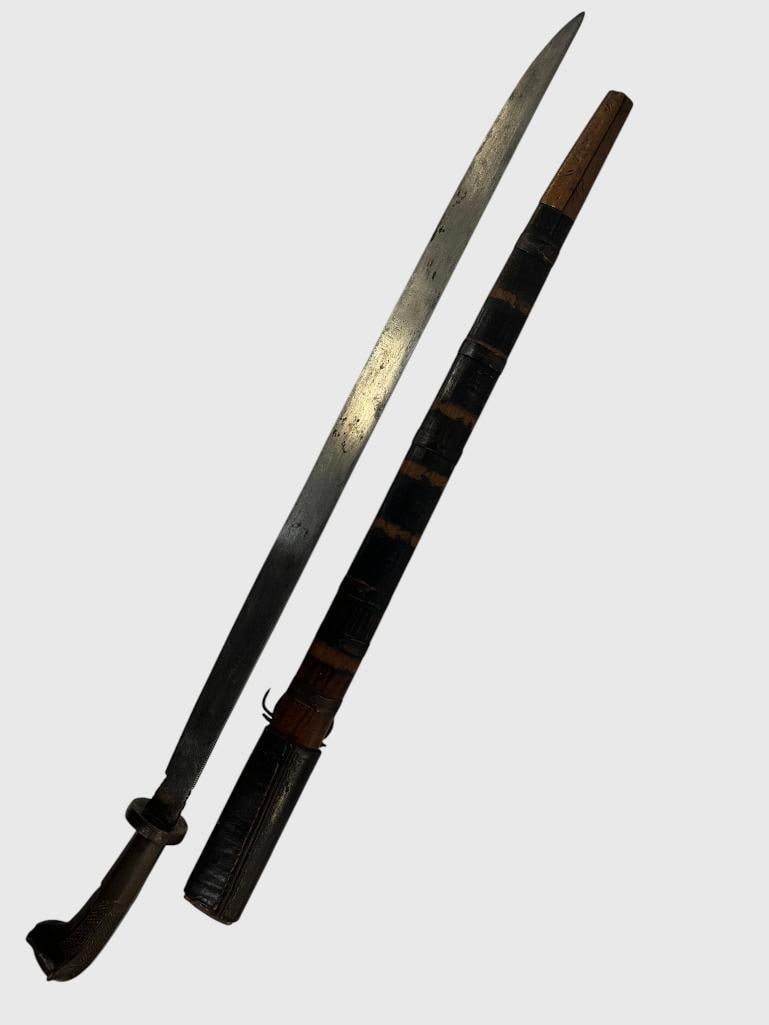 Tribal Sword with carved pommel: Tribal Sword with carved pommel. Blade is etched with letters and symbols. Approx. length in scabbard 31 inches.