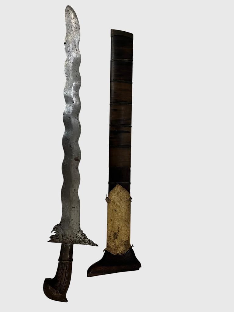 Phillipine Kris Sword with sheath: Phillipine Kris Sword with sheath. Approx. length in scabbard 28 inches.