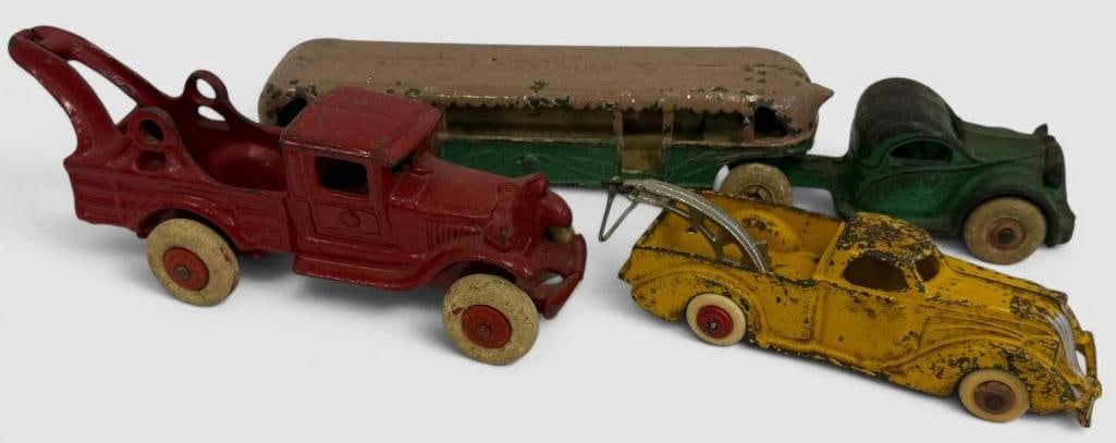 3 Cast Iron Toy Trucks: 3 Cast Iron Toy Trucks. Green truck is by Arcade. Approx. 11 x 2 x 2 inches.