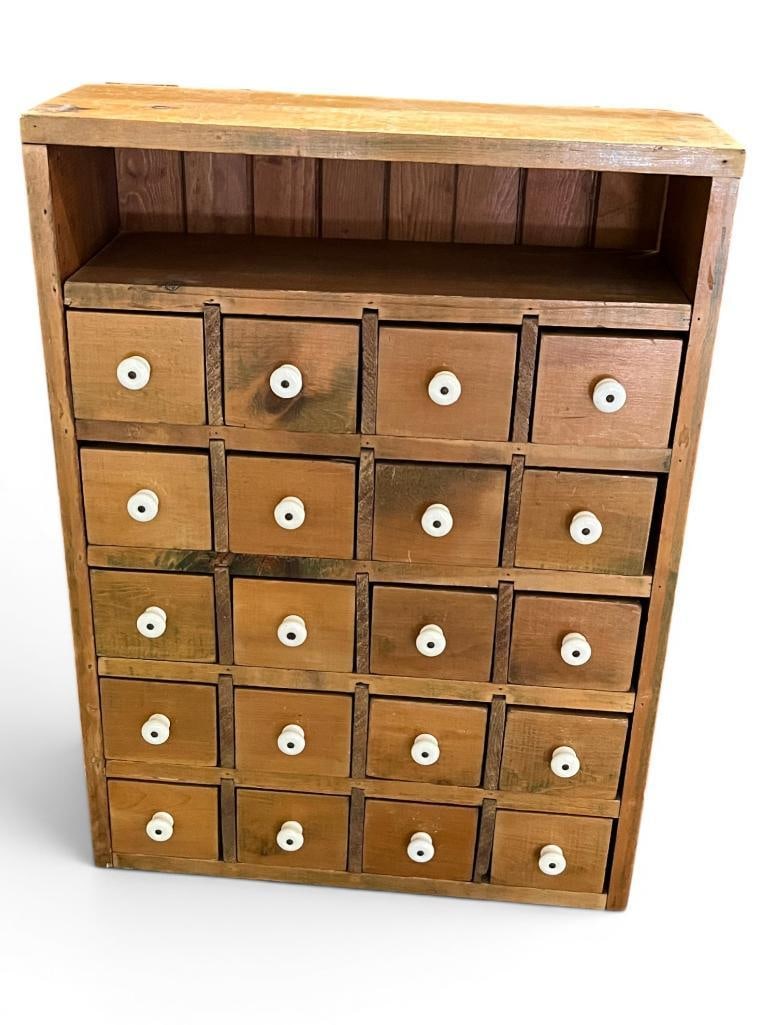 16 Drawer Pine Apothecary Cabinet: 16 Drawer Pine Apothecary Cabinet with porcelain knobs. Approx. 29.5 x 21.5 x 9 inches.
