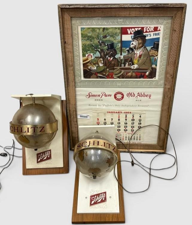 Simon Pure Calendar and Schlitz Wall Sconces: Simon Pure Advertising Calendar and Schlitz Wall Sconces. 3 pieces. Frame approx. 30.5 x 21.5 inches.