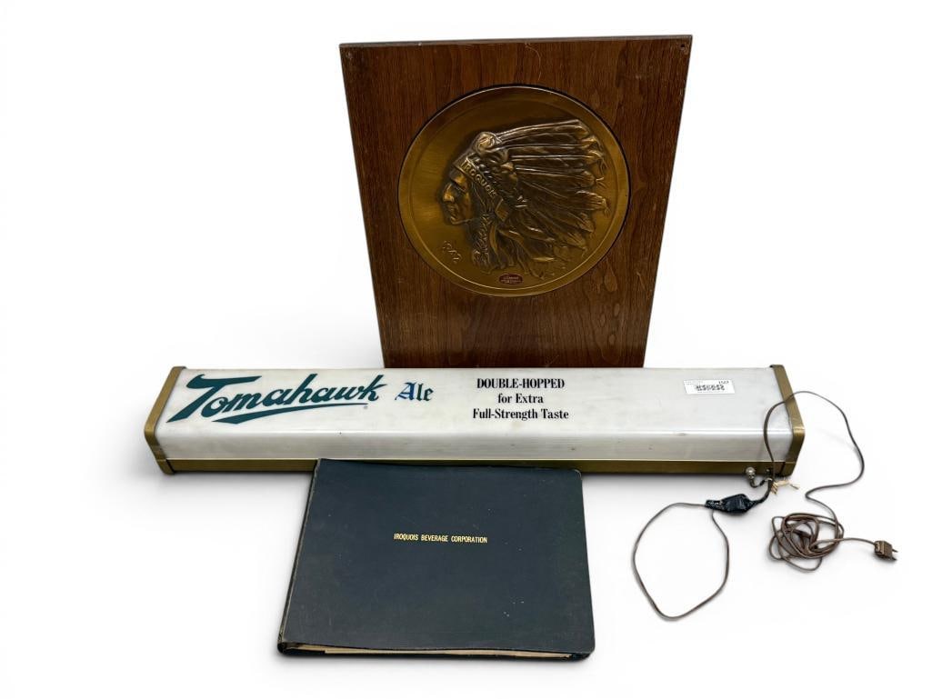 Iroquois Tomahawk Ale Light Up Sign: Iroquois Tomahawk Ale Light Up Advertising Sign. Approx. 36.5 x 5 x 4 inches. Also includes Iroquois sign and binder. 3 pieces.